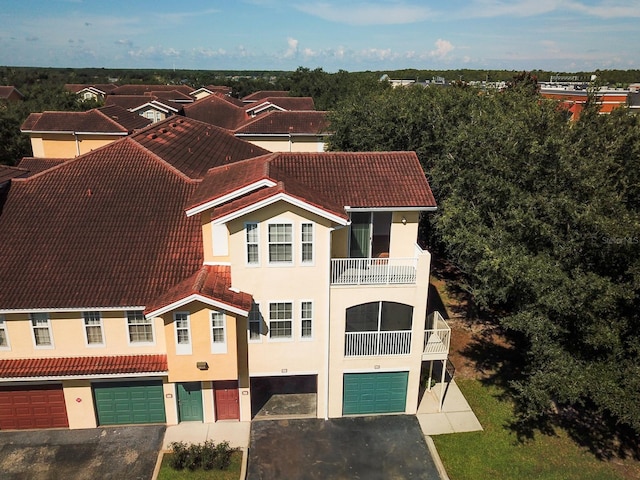 12106 Poppy Field Ln Unit 107, Orlando, FL 32837 - view of front of property featuring stucco siding, a garage, a tile roof, and driveway