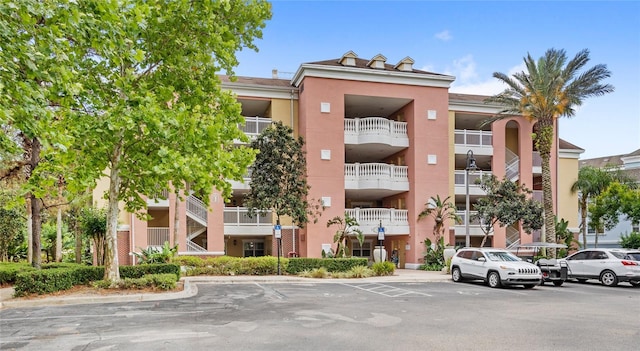 7650 Whisper Way Unit 104, Reunion, FL 34747 - view of apartment building / complex featuring uncovered parking