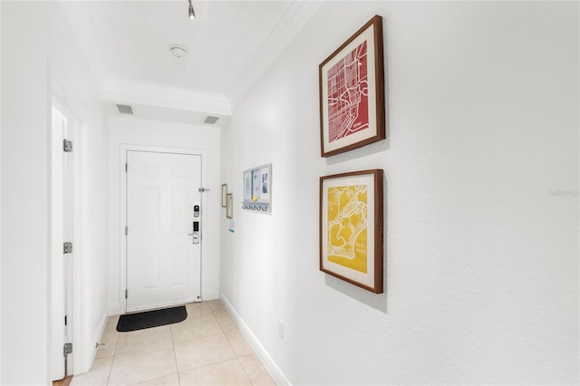 7650 Whisper Way Unit 104, Reunion, FL 34747 - entryway with crown molding, light tile patterned flooring, and baseboards