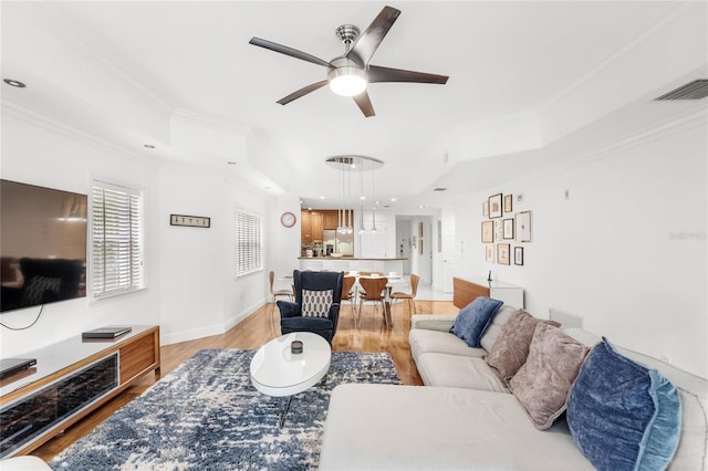 7650 Whisper Way Unit 104, Reunion, FL 34747 - living area featuring a tray ceiling, ornamental molding, a ceiling fan, light wood-type flooring, and recessed lighting