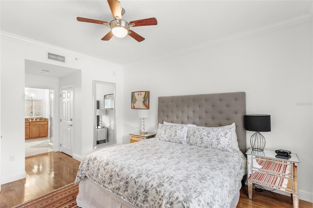 7650 Whisper Way Unit 104, Reunion, FL 34747 - bedroom featuring crown molding, wood finished floors, and baseboards