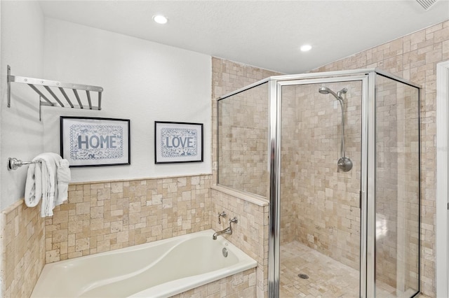 7650 Whisper Way Unit 104, Reunion, FL 34747 - bathroom featuring a garden tub, a shower stall, and recessed lighting