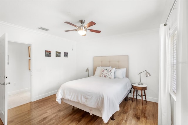 7650 Whisper Way Unit 104, Reunion, FL 34747 - bedroom with ornamental molding, baseboards, wood finished floors, and ceiling fan