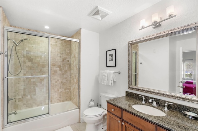 7650 Whisper Way Unit 104, Reunion, FL 34747 - full bathroom featuring vanity, toilet, enclosed tub / shower combo, and tile patterned flooring