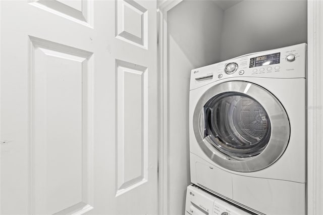 7650 Whisper Way Unit 104, Reunion, FL 34747 - laundry area featuring stacked washer / dryer