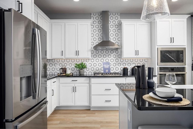 1341 Lumpini St, Saint Cloud, FL 34771 - kitchen with stainless steel appliances, wall chimney range hood, dark countertops, white cabinets, and recessed lighting
