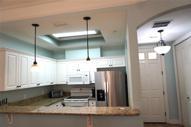 1320 NW 3rd Ave Unit 238, Gainesville, FL 32603 - kitchen featuring white appliances, white cabinets, dark stone countertops, and a peninsula