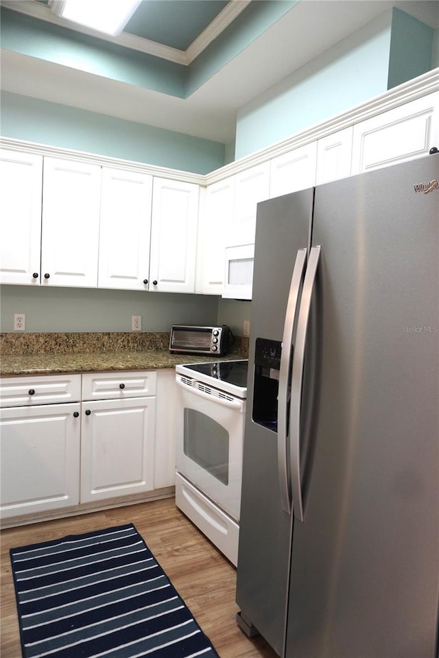 1320 NW 3rd Ave Unit 238, Gainesville, FL 32603 - kitchen featuring white appliances, white cabinetry, light wood-style flooring, crown molding, and dark stone counters