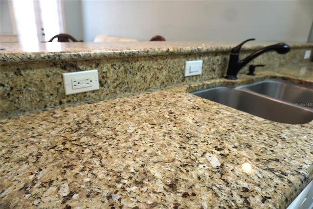 1320 NW 3rd Ave Unit 238, Gainesville, FL 32603 - kitchen view of a sink, light stone countertops, and decorative backsplash