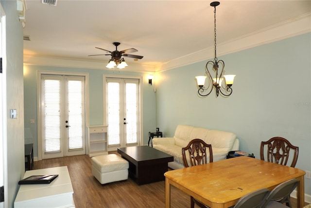 1320 NW 3rd Ave Unit 238, Gainesville, FL 32603 - dining room featuring french doors, wood finished floors, ceiling fan, crown molding, and a chandelier