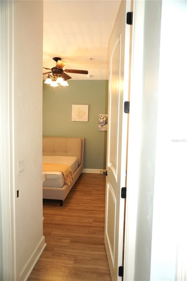 1320 NW 3rd Ave Unit 238, Gainesville, FL 32603 - bedroom featuring baseboards, light wood-type flooring, and ceiling fan