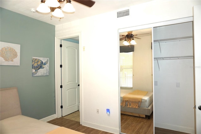 1320 NW 3rd Ave Unit 238, Gainesville, FL 32603 - bedroom with wood finished floors, a closet, baseboards, and a ceiling fan