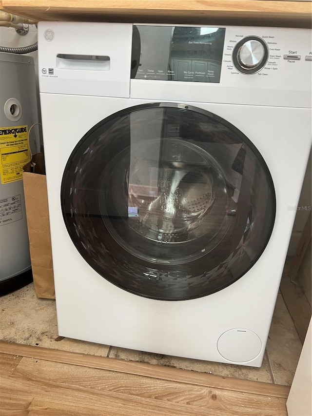 1320 NW 3rd Ave Unit 238, Gainesville, FL 32603 - laundry room with washer / clothes dryer, water heater, and light wood finished floors