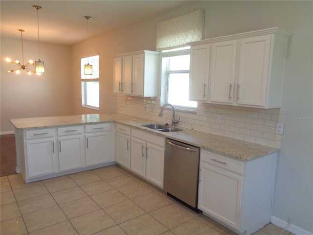 2451 Strandhill St, Orlando, FL 32824 - kitchen featuring a sink, stainless steel dishwasher, a peninsula, tasteful backsplash, and white cabinetry