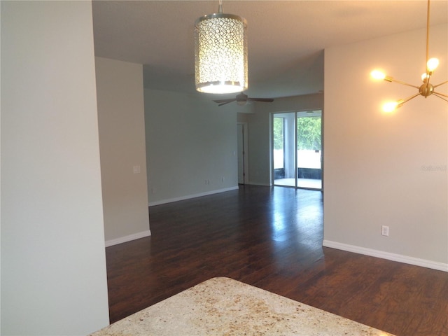 2451 Strandhill St, Orlando, FL 32824 - unfurnished room with wood finished floors, a chandelier, and baseboards