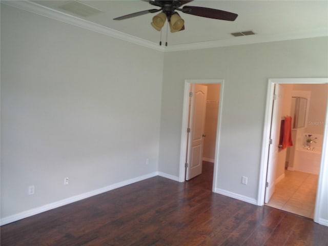 2451 Strandhill St, Orlando, FL 32824 - unfurnished bedroom featuring crown molding, a walk in closet, wood finished floors, baseboards, and ensuite bath