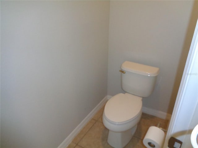 2451 Strandhill St, Orlando, FL 32824 - bathroom with toilet, tile patterned flooring, and baseboards