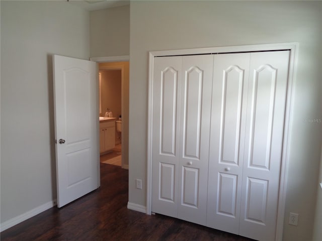 2451 Strandhill St, Orlando, FL 32824 - unfurnished bedroom with dark wood-style flooring, a closet, and baseboards
