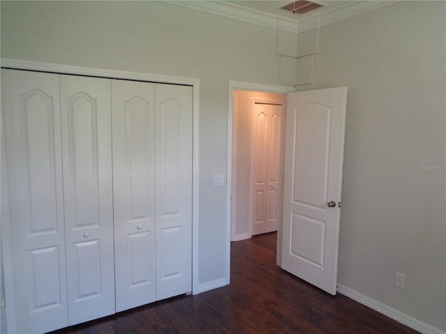 2451 Strandhill St, Orlando, FL 32824 - unfurnished bedroom with a closet, dark wood finished floors, baseboards, and crown molding