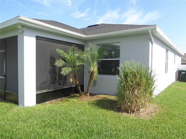 2451 Strandhill St, Orlando, FL 32824 - view of side of property with a lawn, stucco siding, and a shingled roof