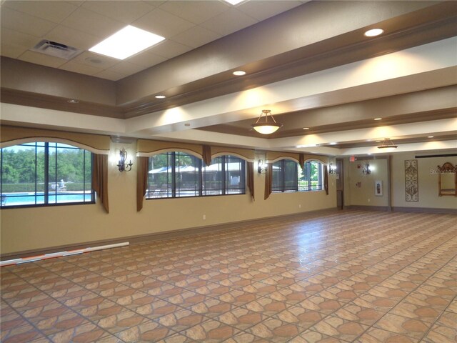 2451 Strandhill St, Orlando, FL 32824 - empty room featuring stone finish flooring, baseboards, and a raised ceiling