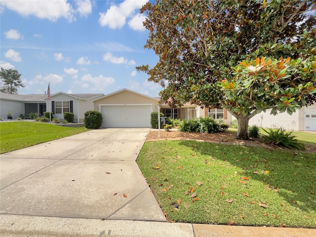 9514 SE 168th Maplesong Ln, The Villages, FL 32162 - view of front facade with an attached garage, concrete driveway, and a front yard