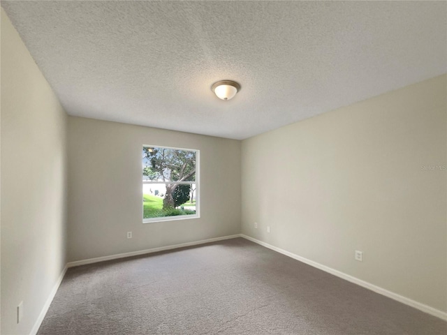 9514 SE 168th Maplesong Ln, The Villages, FL 32162 - empty room featuring dark colored carpet, baseboards, and a textured ceiling