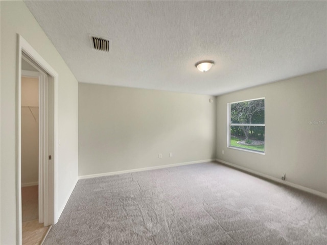 9514 SE 168th Maplesong Ln, The Villages, FL 32162 - carpeted spare room featuring a textured ceiling and baseboards