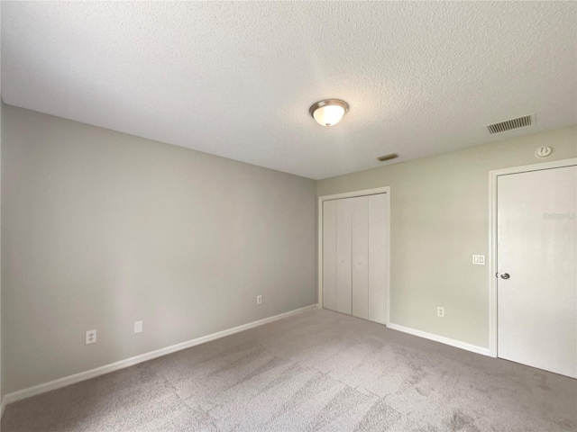 9514 SE 168th Maplesong Ln, The Villages, FL 32162 - unfurnished bedroom featuring baseboards, carpet floors, a textured ceiling, and a closet