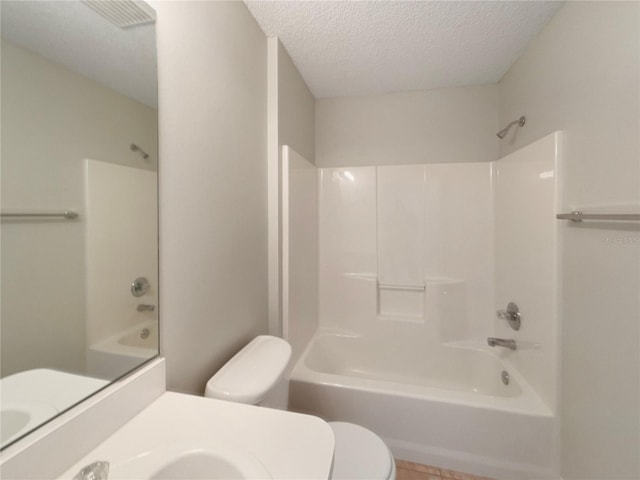 9514 SE 168th Maplesong Ln, The Villages, FL 32162 - full bathroom with toilet, a textured ceiling, shower / bathtub combination, vanity, and tile patterned floors