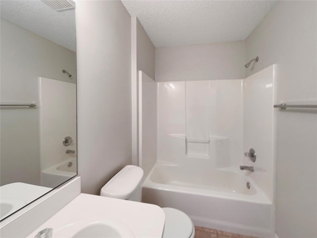 9514 SE 168th Maplesong Ln, The Villages, FL 32162 - bathroom featuring toilet, a textured ceiling, shower / tub combination, and vanity