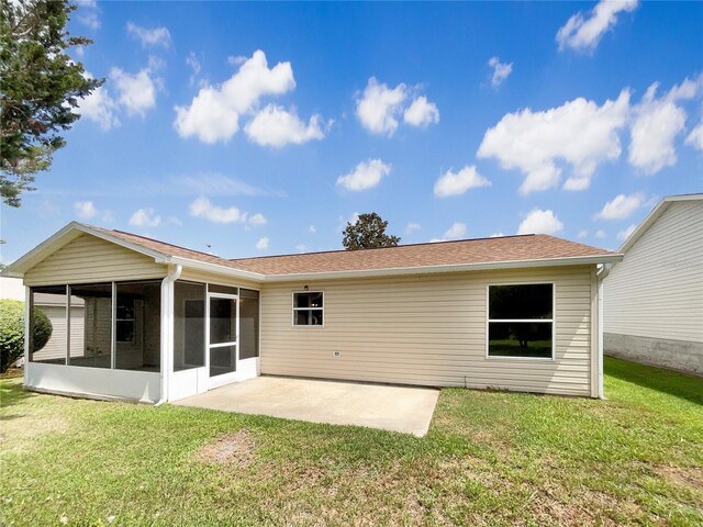9514 SE 168th Maplesong Ln, The Villages, FL 32162 - back of property with a sunroom, a patio, a yard, and a shingled roof