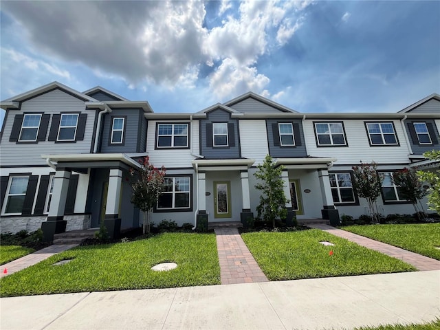 1356 Lumpini St, Saint Cloud, FL 34771 - townhome / multi-family property with a front lawn and stucco siding