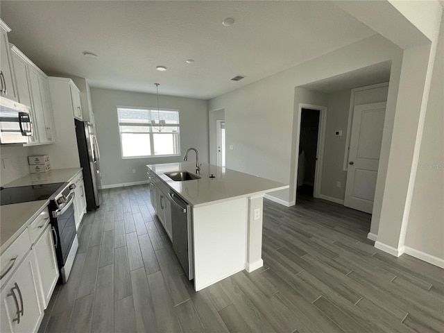 1356 Lumpini St, Saint Cloud, FL 34771 - kitchen with stainless steel appliances, dark wood-style floors, an island with sink, and white cabinets