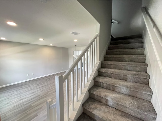 1356 Lumpini St, Saint Cloud, FL 34771 - stairway featuring wood finished floors, recessed lighting, and a chandelier