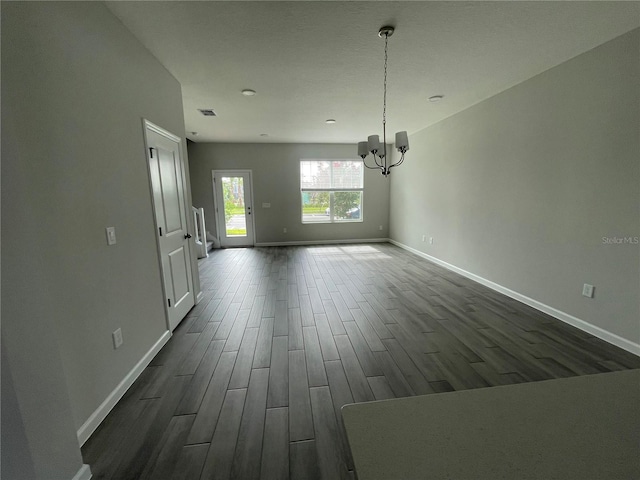 1356 Lumpini St, Saint Cloud, FL 34771 - unfurnished dining area with a chandelier and dark wood-style flooring