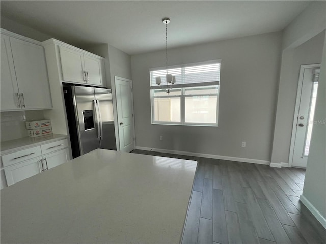 1356 Lumpini St, Saint Cloud, FL 34771 - kitchen featuring stainless steel fridge with ice dispenser, dark wood-style floors, a chandelier, white cabinetry, and light countertops