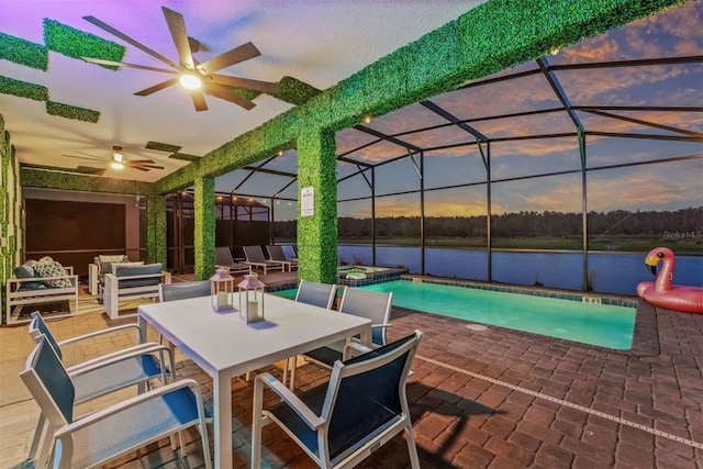 4161 Paragraph Dr, Kissimmee, FL 34746 - view of swimming pool with a water view, a patio area, a ceiling fan, a pool with connected hot tub, and a lanai
