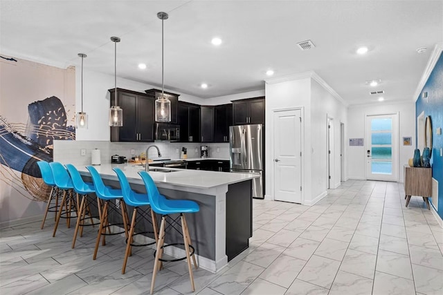 4161 Paragraph Dr, Kissimmee, FL 34746 - kitchen with stainless steel appliances, light countertops, a peninsula, a kitchen bar, and crown molding