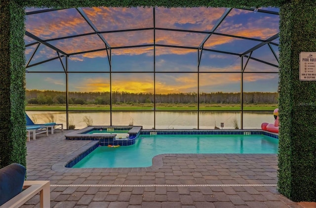 4161 Paragraph Dr, Kissimmee, FL 34746 - view of pool with a water view, a patio area, a pool with connected hot tub, and glass enclosure