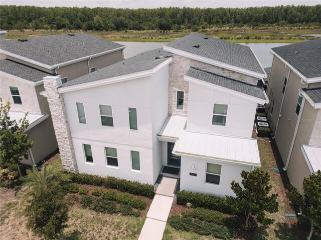 4161 Paragraph Dr, Kissimmee, FL 34746 - view of front facade with a standing seam roof, stucco siding, metal roof, and a water view