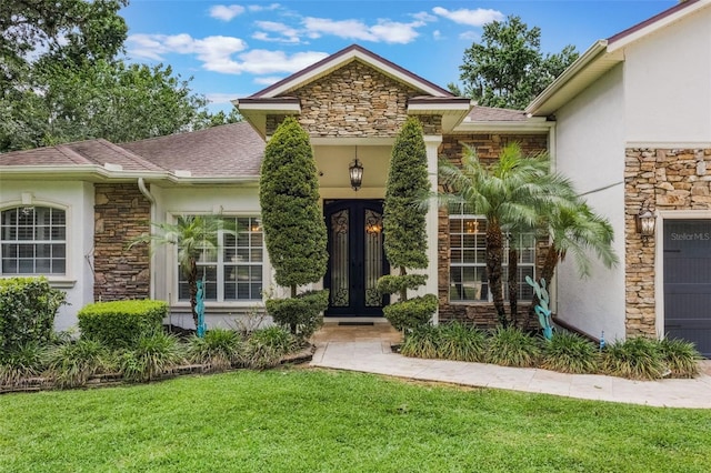 1874 Royal Majesty Ct, Oviedo, FL 32765 - property entrance featuring stone siding, french doors, and stucco siding