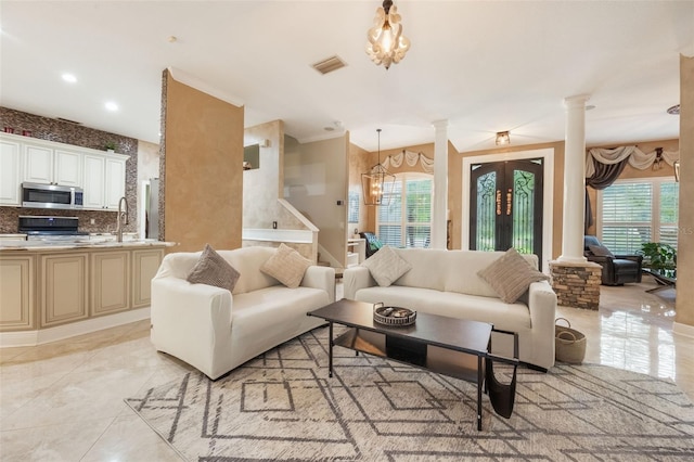 1874 Royal Majesty Ct, Oviedo, FL 32765 - living area featuring decorative columns, healthy amount of natural light, a chandelier, french doors, and recessed lighting