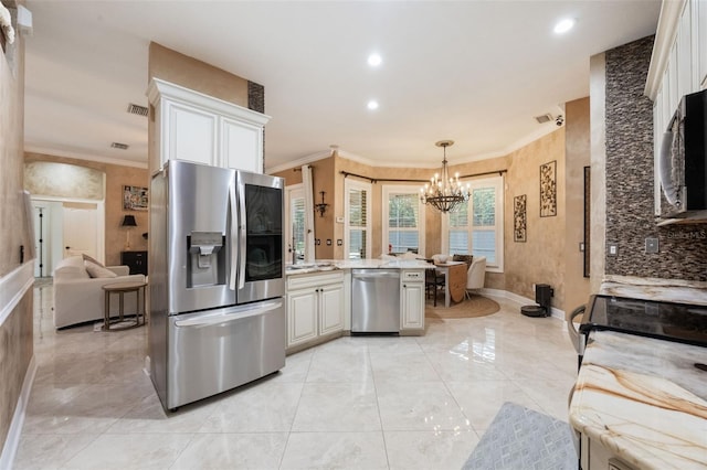 1874 Royal Majesty Ct, Oviedo, FL 32765 - kitchen featuring stainless steel appliances, crown molding, a chandelier, white cabinets, and pendant lighting