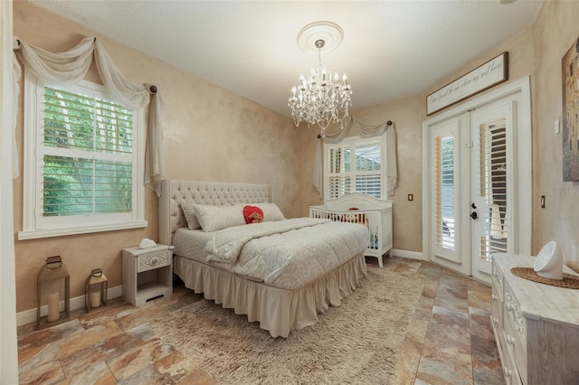 1874 Royal Majesty Ct, Oviedo, FL 32765 - bedroom featuring stone tile flooring, access to outside, a chandelier, and baseboards