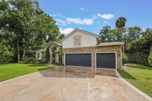 1874 Royal Majesty Ct, Oviedo, FL 32765 - view of front of home with stone siding, concrete driveway, a front yard, stucco siding, and an attached garage