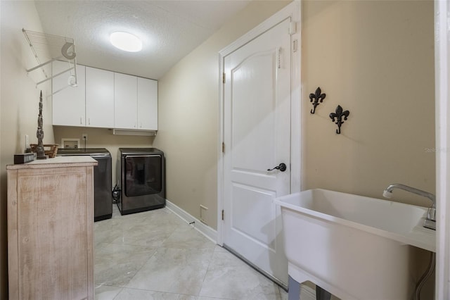 1874 Royal Majesty Ct, Oviedo, FL 32765 - laundry area featuring separate washer and dryer, cabinet space, a textured ceiling, and baseboards