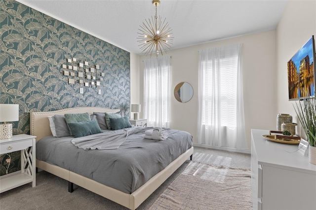 1809 Tropical Palms Cir, Kissimmee, FL 34747 - bedroom with wallpapered walls, a chandelier, and light carpet