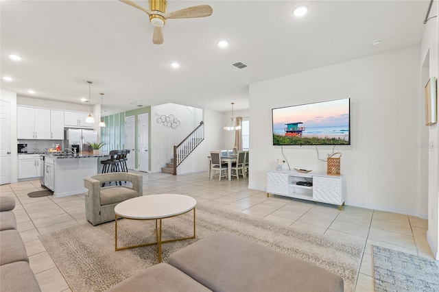 1809 Tropical Palms Cir, Kissimmee, FL 34747 - living area featuring light tile patterned flooring, recessed lighting, stairs, ceiling fan, and a chandelier