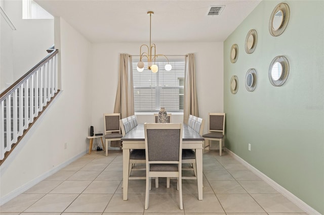 1809 Tropical Palms Cir, Kissimmee, FL 34747 - dining area featuring a chandelier, light tile patterned flooring, and stairs